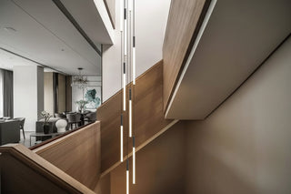 Staircase pendant light human body sensing loft duplex villa Nordic long strip rotating designer hollow minimalist lighting fixture image 0