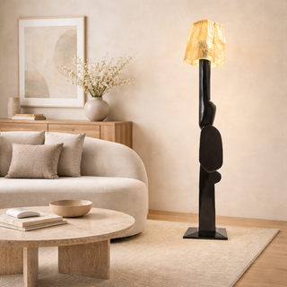 Modern living room with a stylish floor lamp, beige sofa, and decorative items.