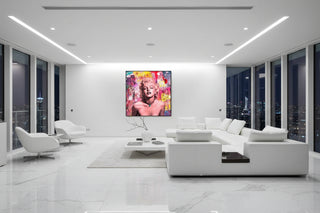Marilyn Monroe pop art canvas with vibrant pink, yellow, and blue graffiti, framed in a modern living room.