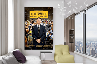 The Wolf of Wall Street Leonardo DiCaprio movie poster canvas art on a white wall in a modern living room.