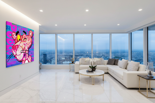 Pink Panther pop art canvas with vibrant pink and blue graffiti, displayed above a modern living room sofa.
